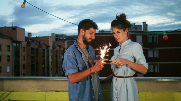 Pareja enciende velas de fuegos artificiales — Vídeo de stock