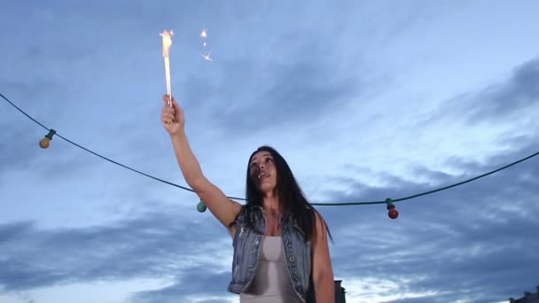 Woman jumping with firework candle — Stock Video