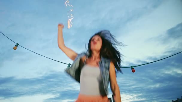 Woman jumping with firework candle — Stock Video