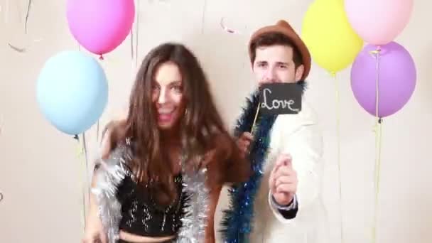 Couple in love in photo booth — Stock Video