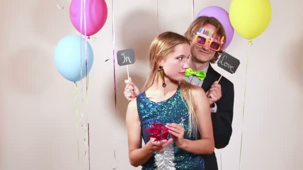 Couple in love in photo booth — Stock Video