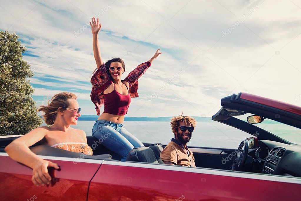  people in the red convertible
