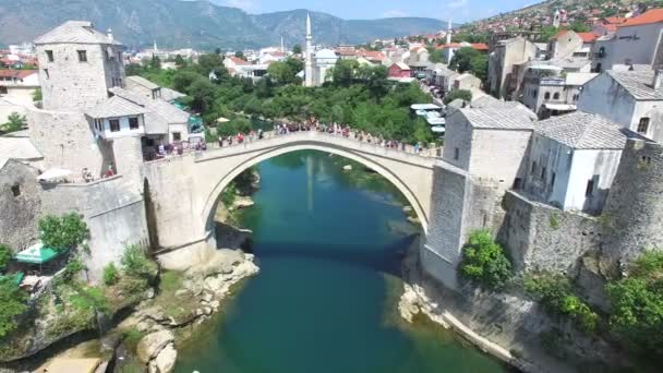people walking over ridge in Mostar