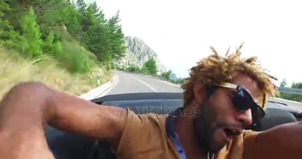 Hombre y mujer cabalgando en convertible — Vídeo de stock