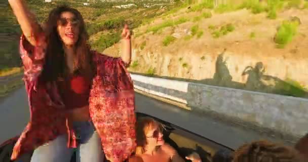 Morena sentado en la capucha de un coche descapotable — Vídeos de Stock