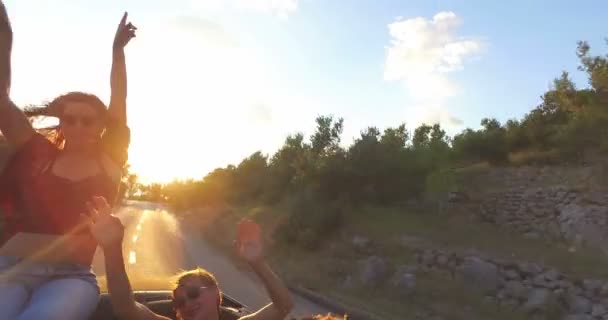 Woman sitting on hood of convertible car — Stock Video