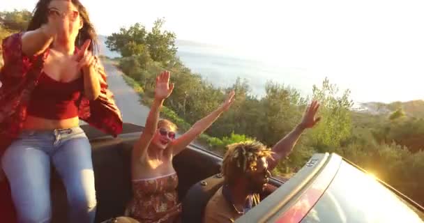 Woman sitting on hood of convertible car — Stock Video