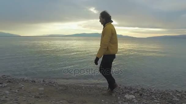 Hombre caminando por la playa — Vídeo de stock