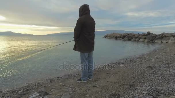 Man fishing on beach — Stock Video