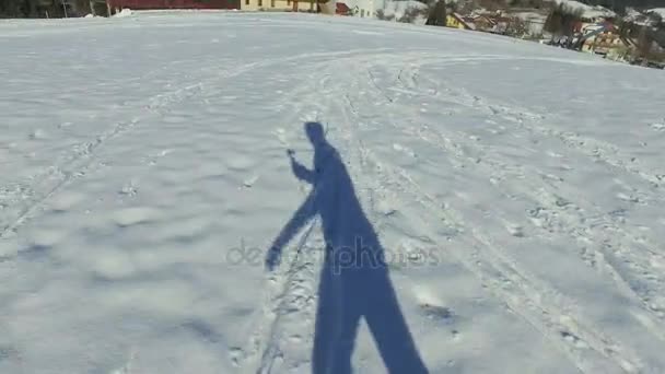 人を実行するシャドウと雪の丘の上 — ストック動画