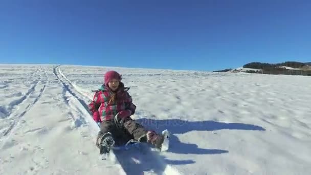 Girl descending hill sledge — Stock Video