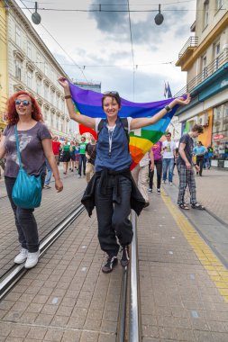 15th Zagreb pride. LGBTIQ activist holding flag. clipart