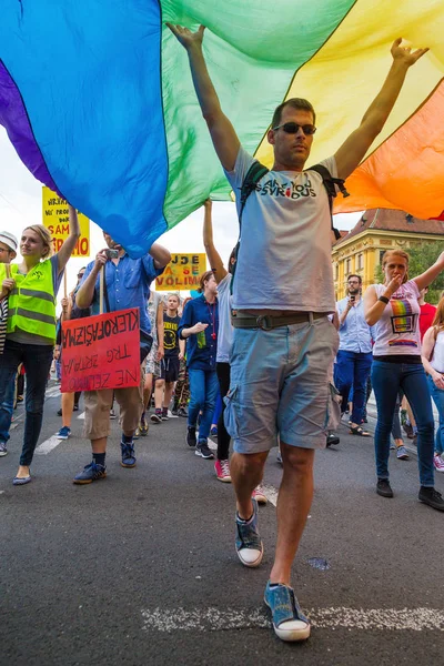 15th Zagreb pride. LGBTIQ activist under big rainbow flag. — Stock Photo, Image