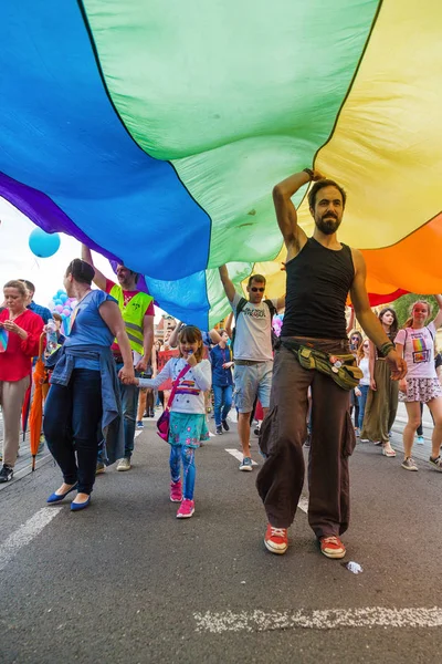 15th Zagreb pride. LGBTIQ activist under big rainbow flag. — Stock Photo, Image