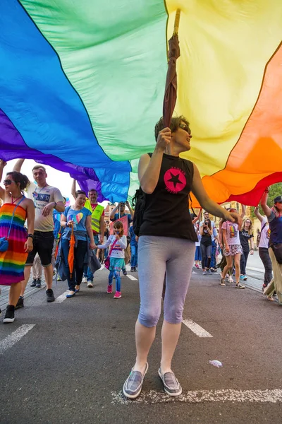 15th Zagreb pride. LGBTIQ activist under big rainbow flag. — Stock Photo, Image