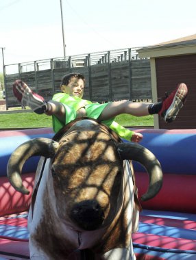 A Boy Rides a Mechanical Bull, Fort Worth Stockyards clipart