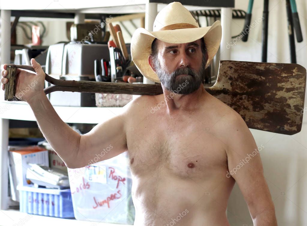 A Bearded Cowboy Puttering in His Tool Shed