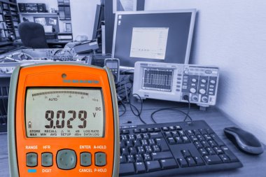 Multimeter on workplace clipart
