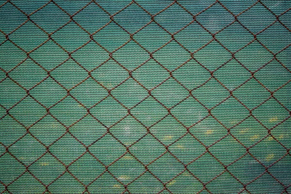 Rusty lattice fence. Old grid. Green texture from striped fabric — Stock Photo, Image