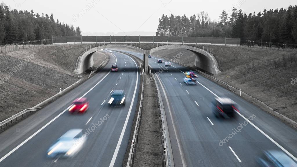 Cars traveling on a highway in landscape. Idea of transport, infrastructure, architecture