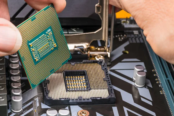 Detalhe de manutenção do processador de computador. Mãos instalando um chip de microprocessador — Fotografia de Stock