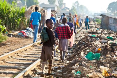 NAIROBI, KENYA - FEBRUARY 6, 2014: Children living in the slums of Kibera on February 6, 2014 in Nairobi, Kenya. The largest slum of Africa is in Nairobi. About 270 thousand people living in Kibera. clipart