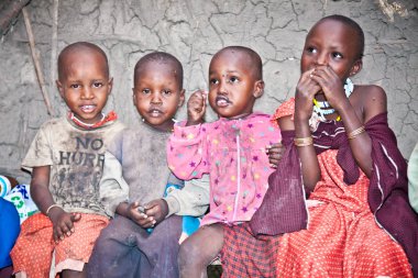 Afrika, Tanzanya-Şubat 9, 2014: portre kameraya gülümseyen bir Afrikalı çocuklar Masai kabilesi köyüne, inek gübresi, 9 Şubat 2014 ile yapılan evde yaşayan. Tanzanya.
