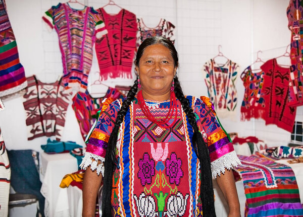 OAXACA MEXICO- DEC 7, 2015: Mexican women selling handicrafts and carpets in Oaxaca on Dec 7, 2015, Mexico.