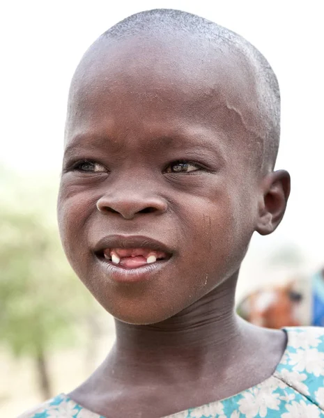 AFRICA, TANZANIA-FEBRUARY 9, 2014: Unidentified girl of Masai tribe looking to the camera on February 9, 2014. Tanzania. Masai people are the most famous nomadic tribe in Africa.