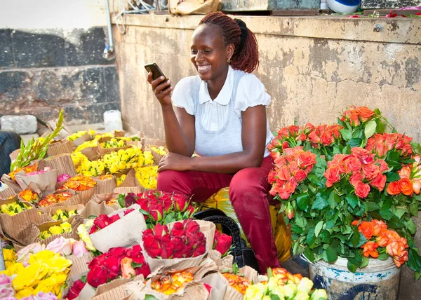 NAIROBI, KENYA-FEBRUARY 5, 2014:  Unidentified black woman sells flowers at old market in centre of Nairobi on February 9, 2014.  Africa.