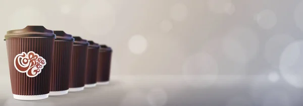 Caffè da asporto. Tazze di caffè Ripple Bokeh sfondo grigio — Foto Stock