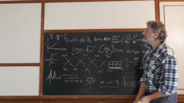 Teacher Wipes Blackboard Lesson — Stock Video