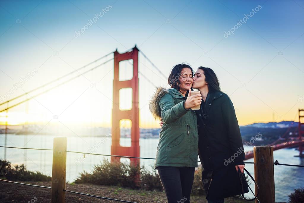 lesbian couple taking selfie