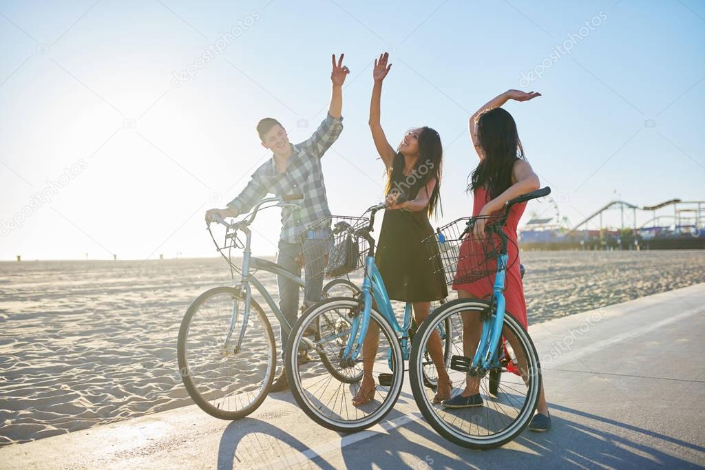 friends on bikes doing high five