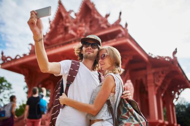 tourists taking photos at temple clipart