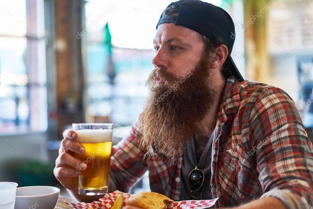 bearded hipster drinking craft beer