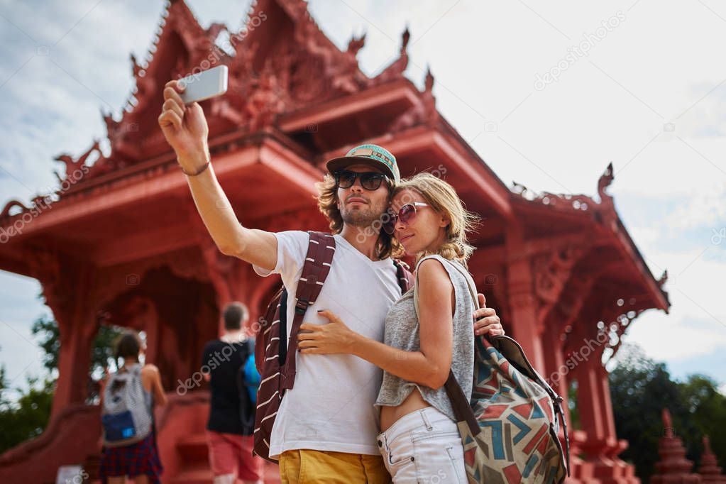 tourists taking photos at temple