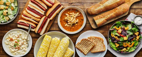 Table top meal with hot dogs, grilled cheese, soup and salad in flat lay composition — Stock Image Table Top Meal Hot Dogs Grilled Cheese Soup Salad Flat Stock Image