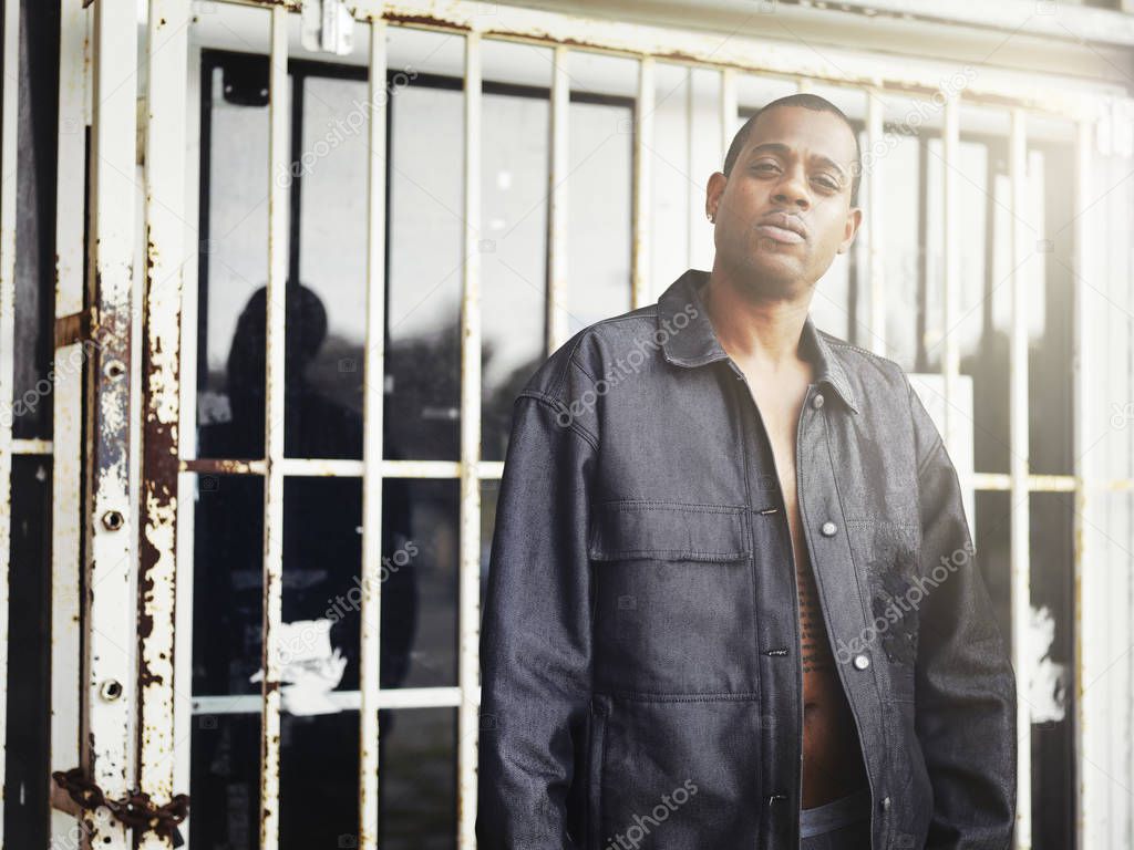 cool african guy in front of abandoned corner store