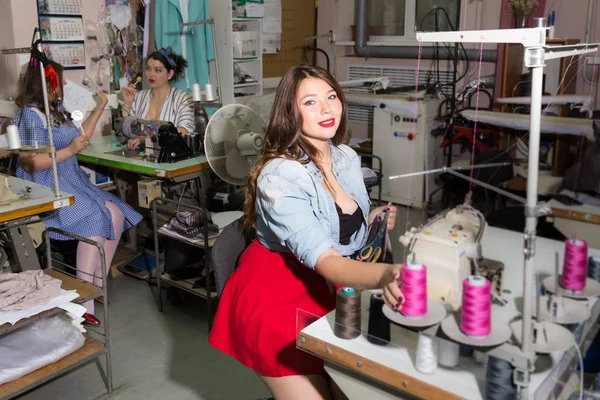 Plus size gorgeous and funny models as clothing factory workers — Stock Photo, Image