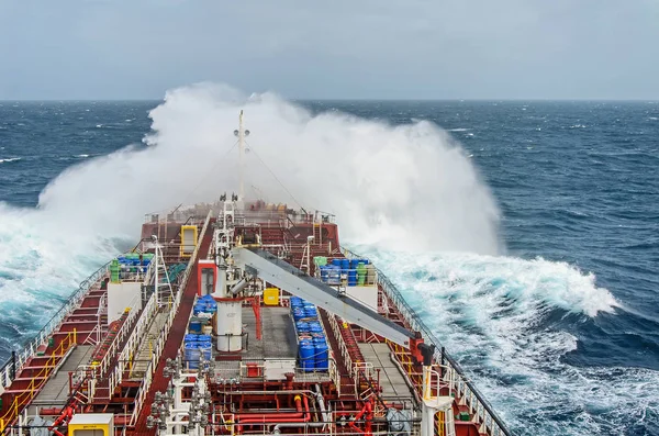 An oil tanker vessel against rage of the ocean