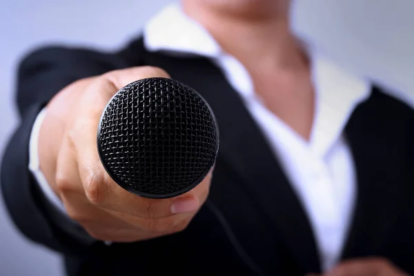 Journalist making speech with microphone