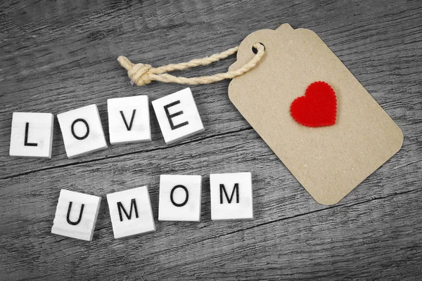 Love you mom wording with red heart sign and paper label