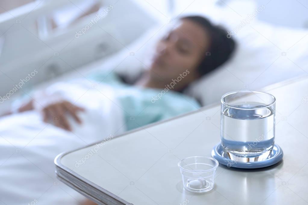 patient caught cold sleeping in bed with medicines and water in 