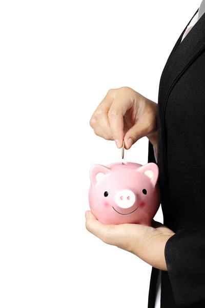 Businesswoman putting a coin into piggy bank isolated with clipp — Stock Photo, Image