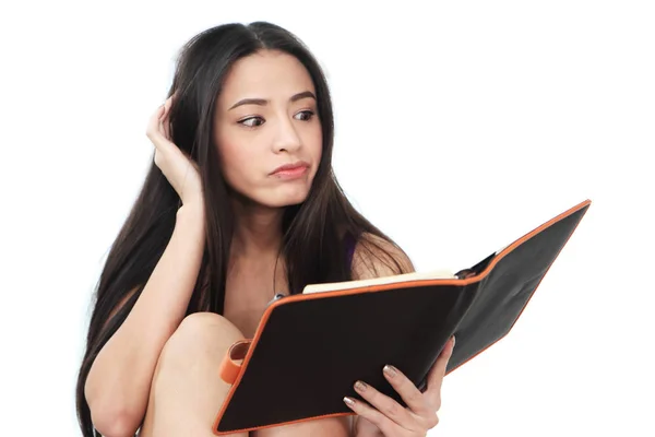 Young woman looking down of the black book — Stock Photo, Image