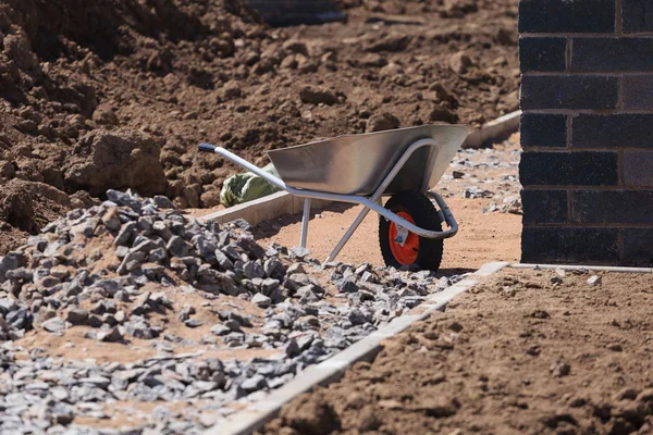 Professional galvanized wheelbarrow on the background of constru