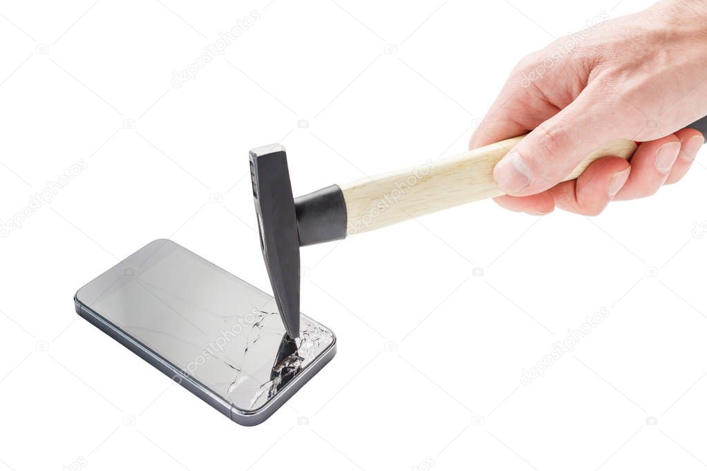 Male hand breaks a smartphone with a hammer against a white back