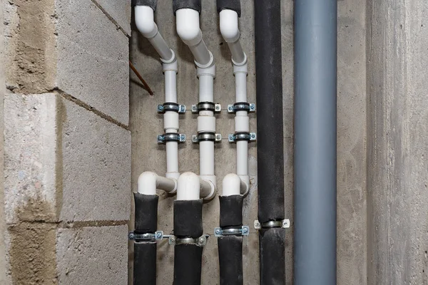 Pipes of heating and water supply system on the background of a