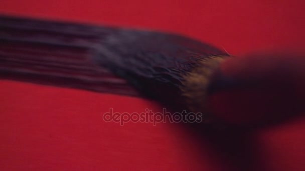 Caligrafía china. Escribir en papel rojo — Vídeos de Stock